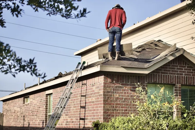 Professional roofer working on a residential roof in Haymarket